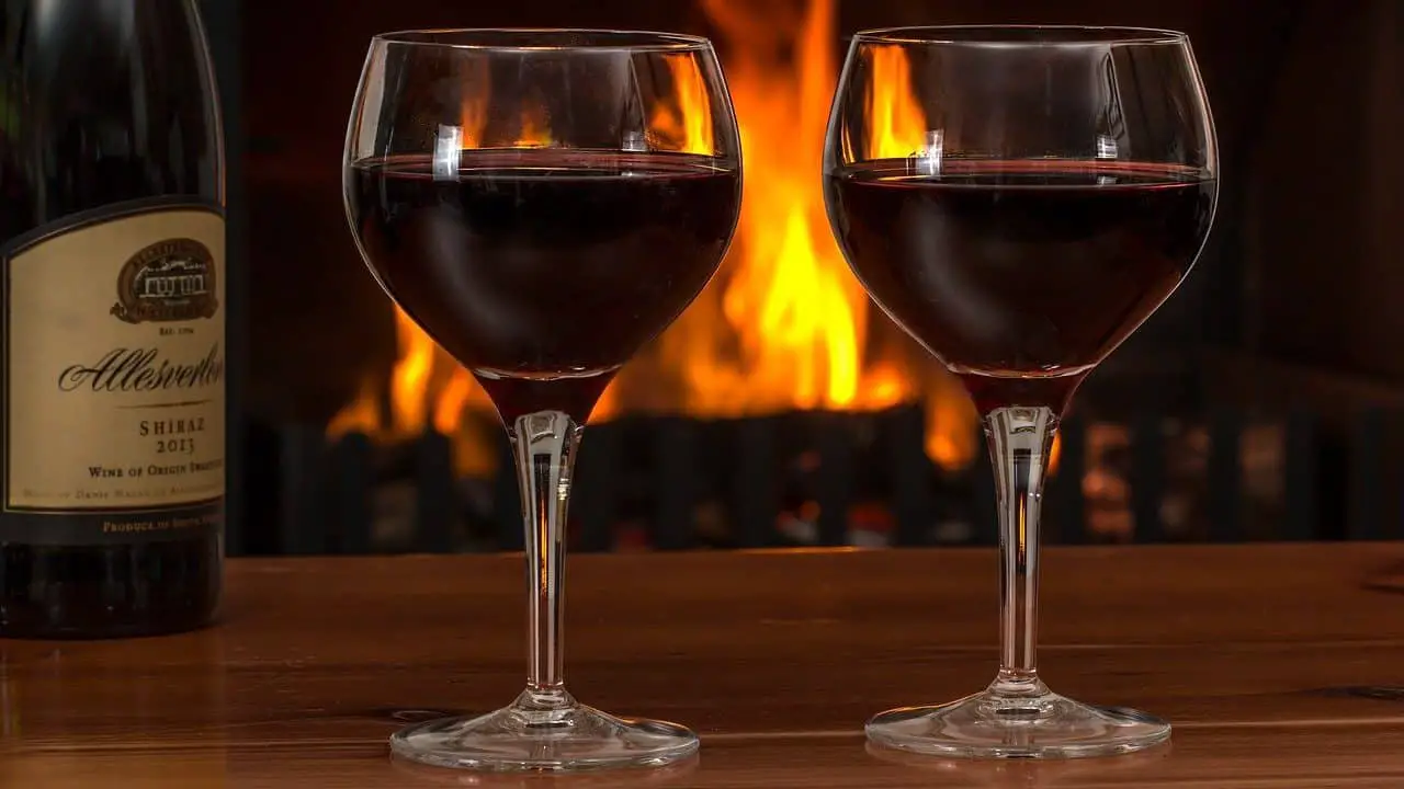 red wine, glasses, log fire